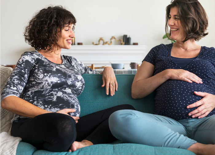 Two pregnant surrogate mothers talking